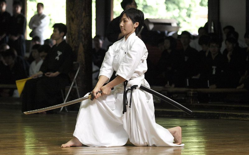 Japanese girl practicing iaido wielding a Iaito Sword