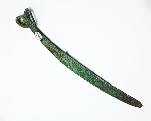 A Shang Dynasty bronze dao with ibex head handle 32cm long