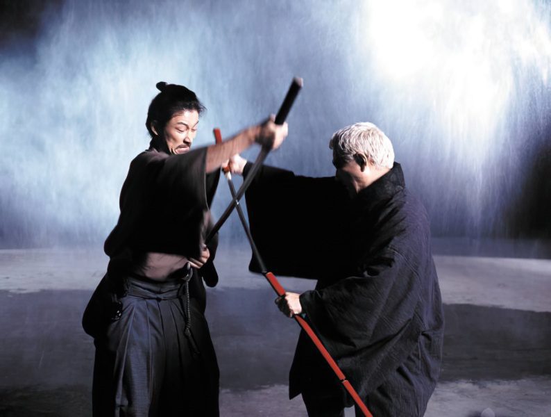 Zatoichi wielding his sword cane in battle